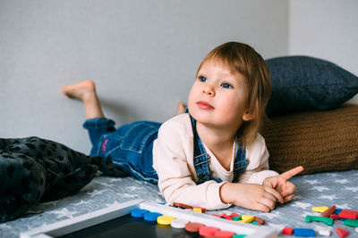 Cute girl playing with toy at home