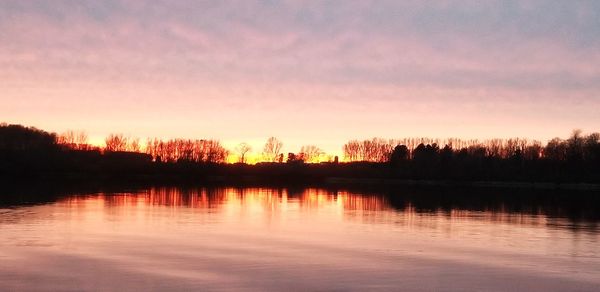Scenic view of lake against sky during sunset