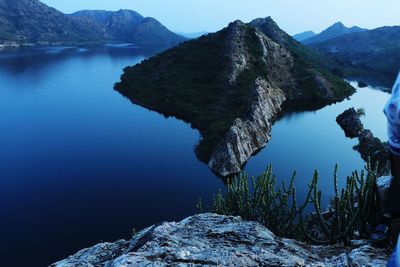 Scenic view of lake and mountains against clear sky