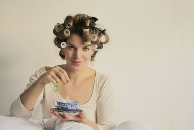 Portrait of a smiling young woman holding ice cream