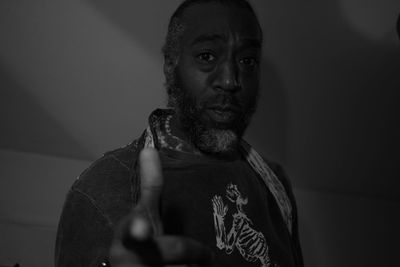 Portrait of man with arms raised
