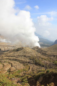 Aerial view of volcanic landscape against sky