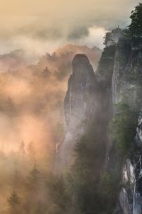 Low angle view of mountain against cloudy sky