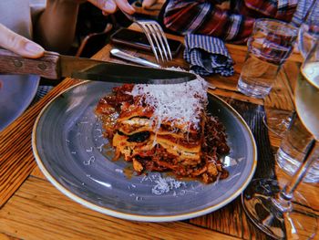 Cropped image of person having food in plate