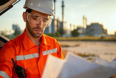 Engineer looking at refinery plans.