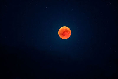 Low angle view of full moon against sky at night