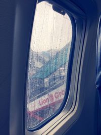 Close-up of car window against sky