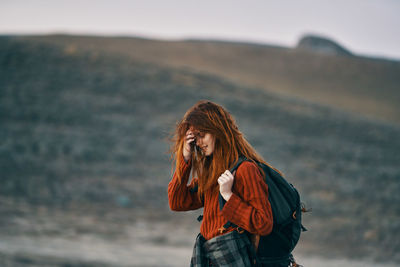 Full length of woman standing against blurred background