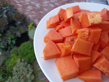 High angle view of chopped fruits in plate on table