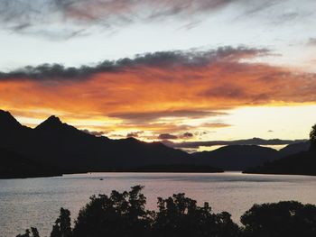 Scenic view of lake against sky during sunset