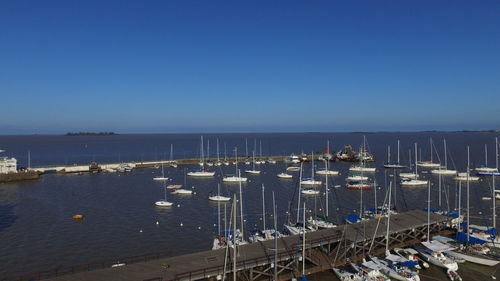 High angle view of harbor against clear blue sky