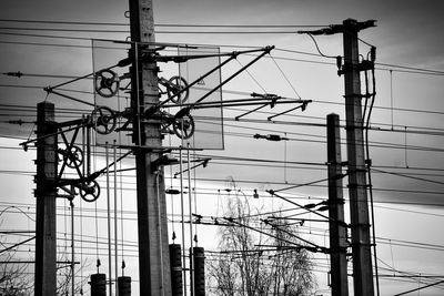 Low angle view of electricity pylon against sky