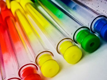 High angle view of multi colored bottles on shelf