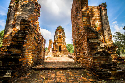 Panoramic view of old temple amidst buildings against sky