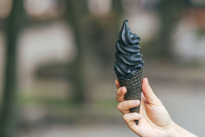 Cropped hand of woman holding ice cream cone