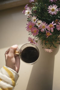 Woman's hand holding a morning cup of coffee