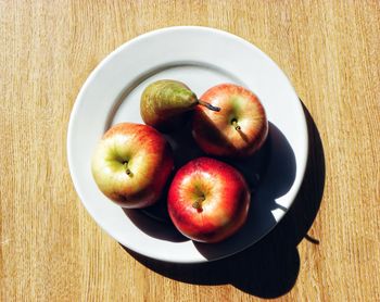 High angle view of apples in plate on table