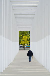 Rear view of woman walking in building