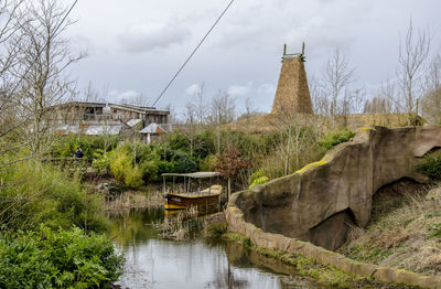 Bridge over river amidst buildings against sky