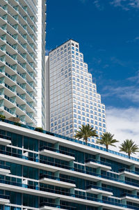 Low angle view of modern building against blue sky