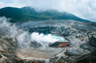 High angle view of lake amidst rock formation against sky