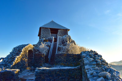 Low angle view of building against clear blue sky