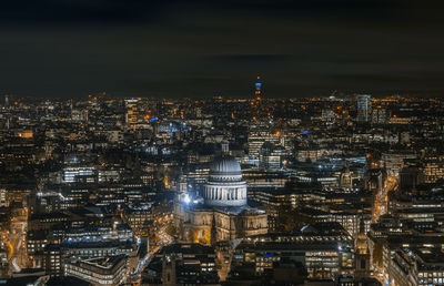 High angle view of city lit up at night