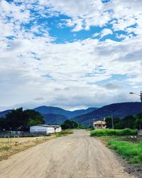 Empty road along countryside landscape