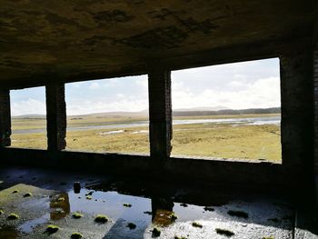 Scenic view of sea against sky seen through window