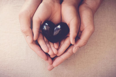 Close-up of woman holding heart shape