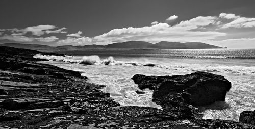 Rocks on beach against sky