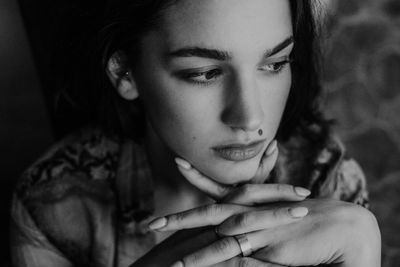 Close-up portrait of young woman looking away