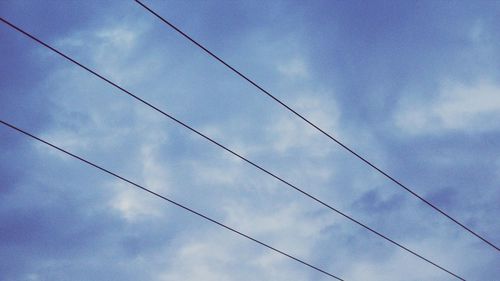 Low angle view of cables against sky