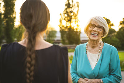 Portrait of smiling woman against sky