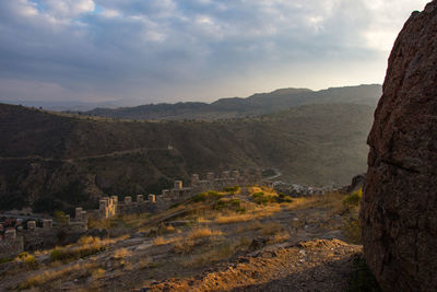 Scenic view of mountains against cloudy sky