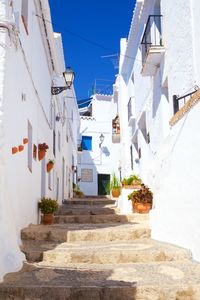 Low angle view of steps amidst whitewashed houses in town