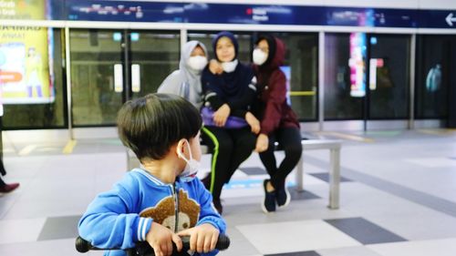 A toddler boy in a public place