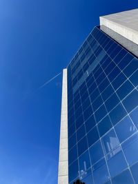 Low angle view of modern building against clear blue sky