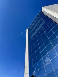 Low angle view of modern building against clear blue sky