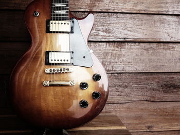 Close-up of guitar hanging on wall