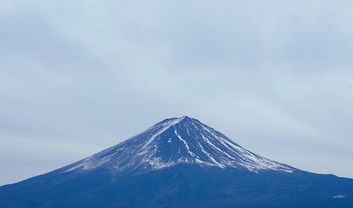 Low angle view of snowcapped mountain against sky