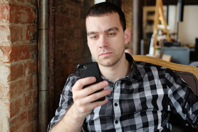 Man using mobile phone at cafe