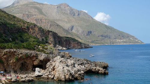 Scenic view of sea and mountains against sky