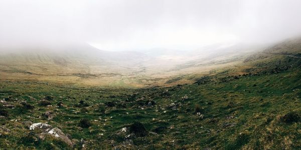 Scenic view of landscape against cloudy sky