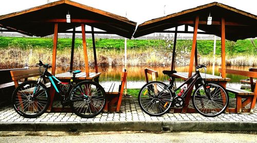 Bicycles parked by water in city
