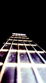 Close-up of guitar against black background