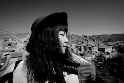 Close-up of woman against built structure