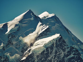 Scenic view of snowcapped mountains against clear sky