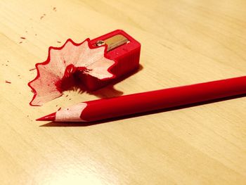 Close-up of red pencils on table