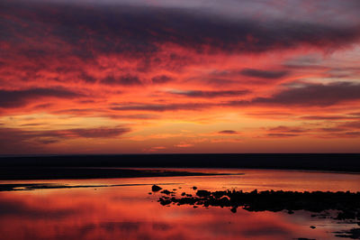 Scenic view of sea against romantic sky at sunset